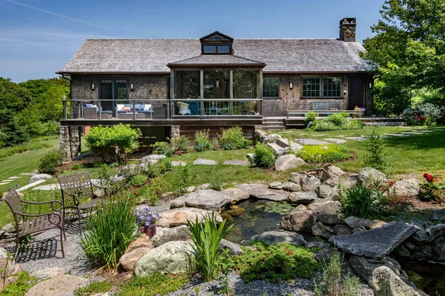 an aerial view of a house with garden space and a patio