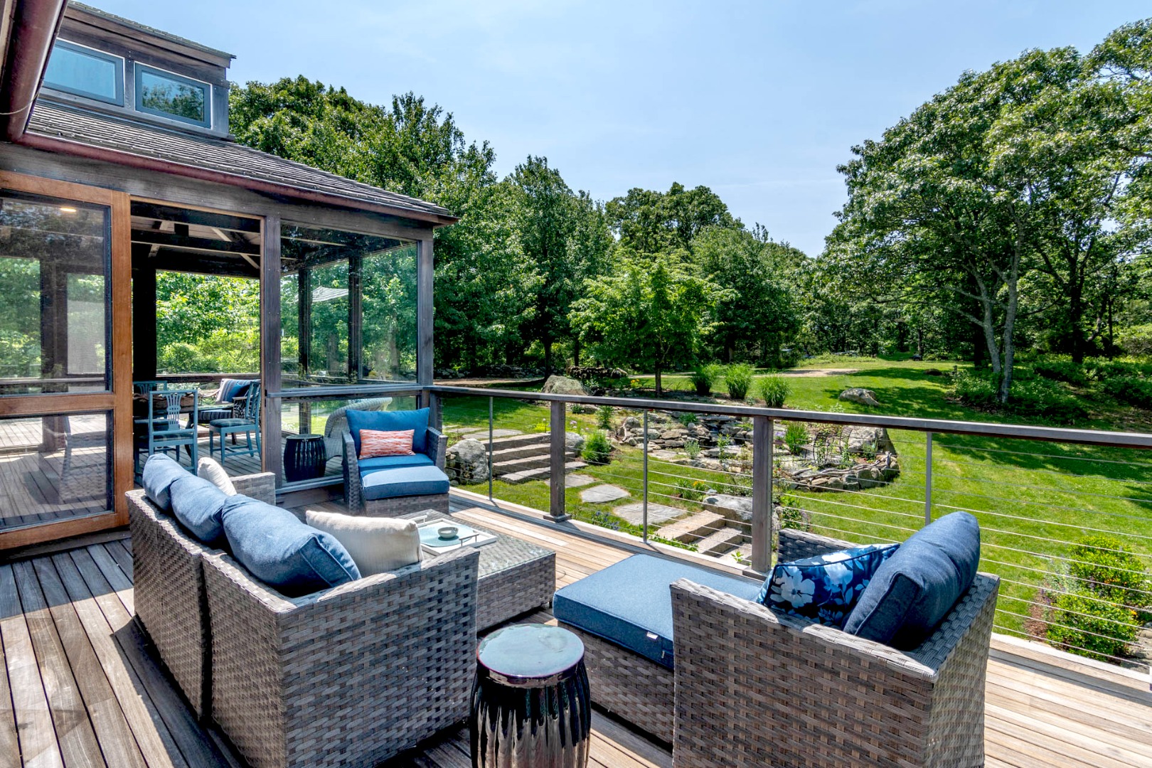15 Old Farm Road Chilmark, MA 02535 - Photo 40 of 51 a view of a patio with couches chairs potted plants with wooden floor and fence