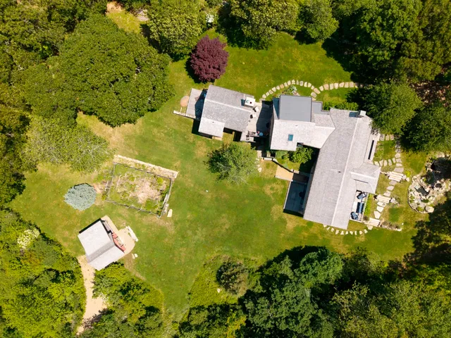 an aerial view of residential house with swimming pool and green space