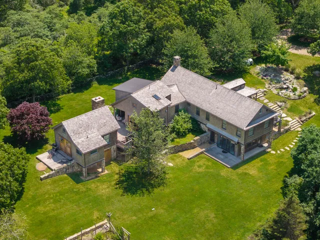 an aerial view of a house with a garden and trees