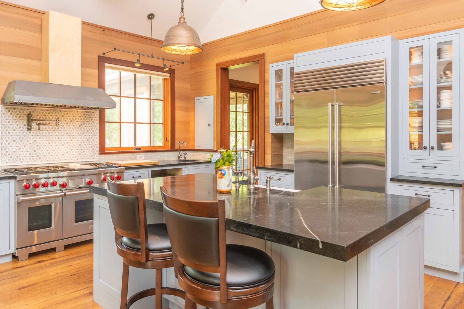 15 Old Farm Road Chilmark, MA 02535 - Photo 7 of 51 a kitchen with a stove a kitchen island a dining table and chairs
