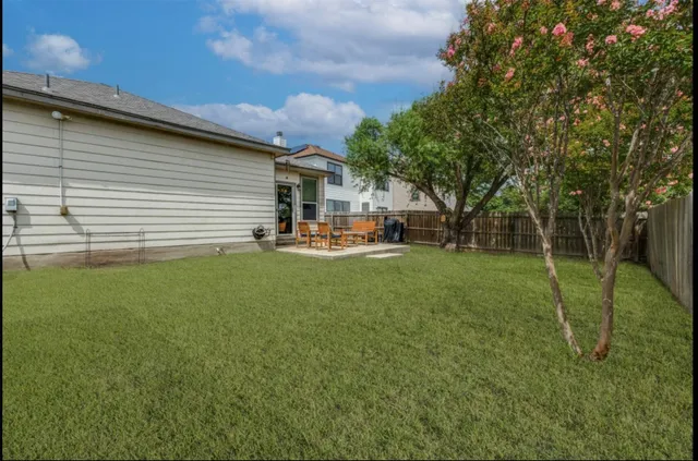 a view of a backyard with sitting area