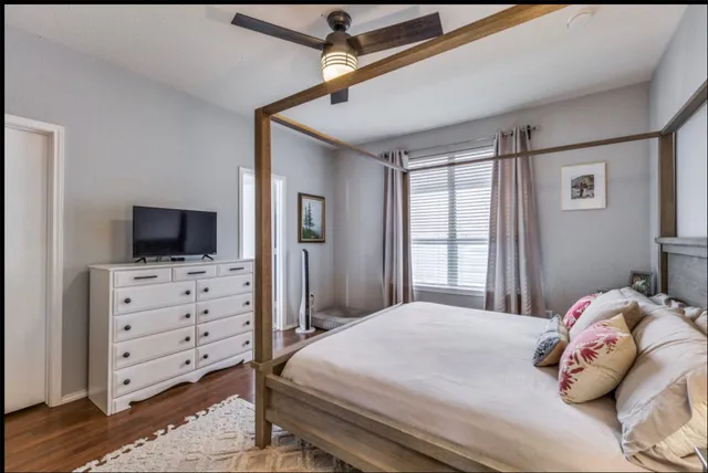 a bedroom with a bed and a television