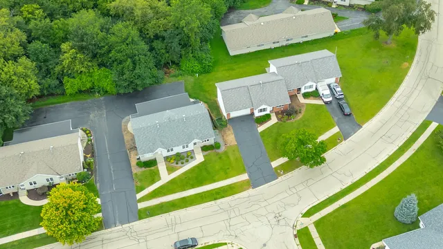 an aerial view of a house with a garden and swimming pool