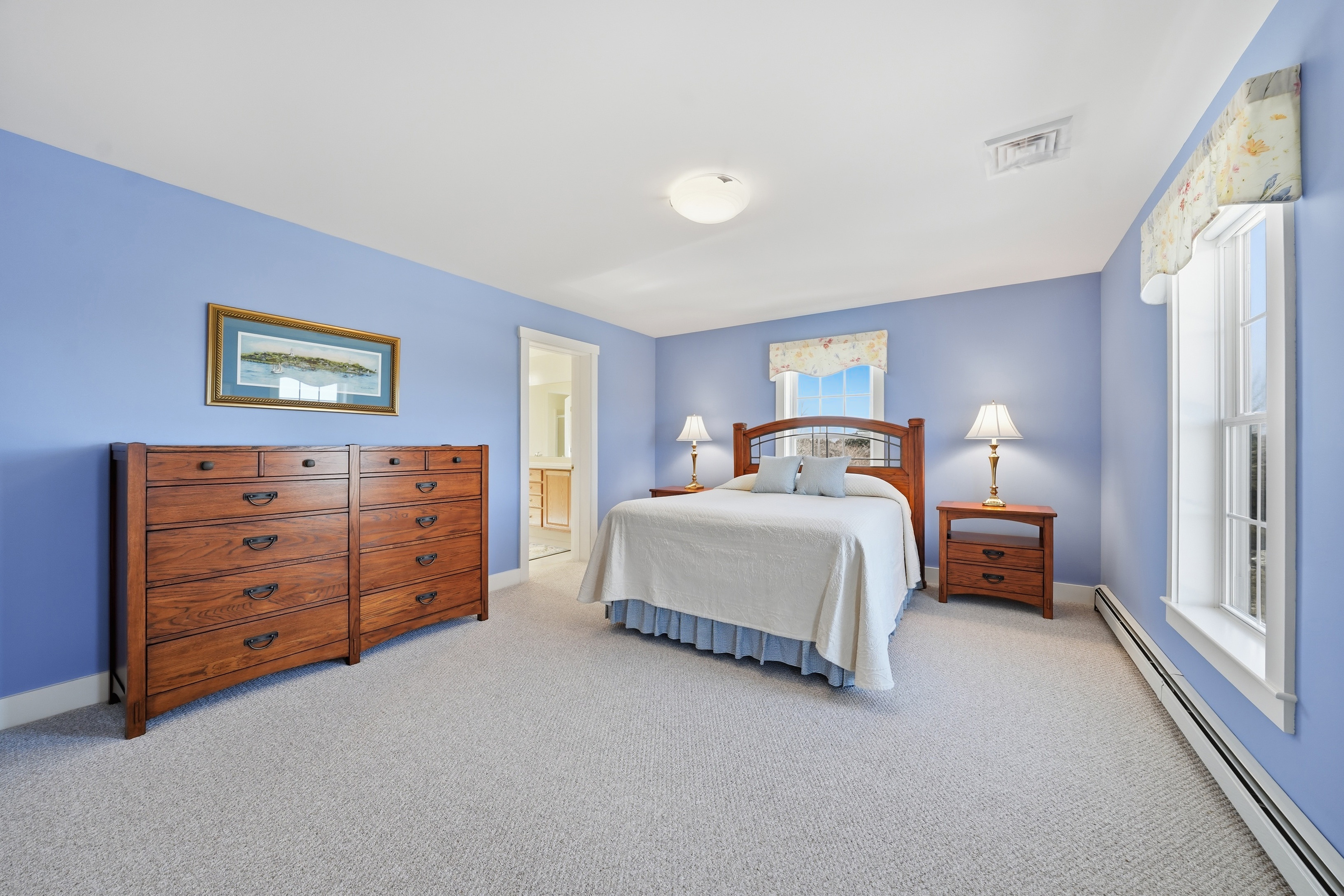 20 Rudder Lane Nantucket, MA 02554 - Photo 22 of 34 a spacious bedroom with a bed and a lamp on dresser