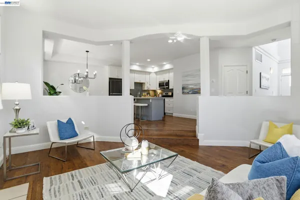 a dining room with furniture a rug and a large window