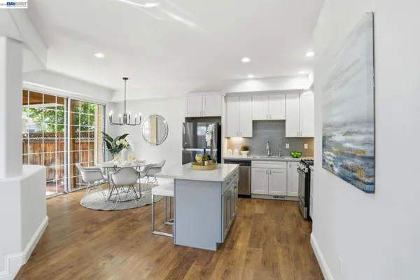 a kitchen with stainless steel appliances a stove microwave and a refrigerator