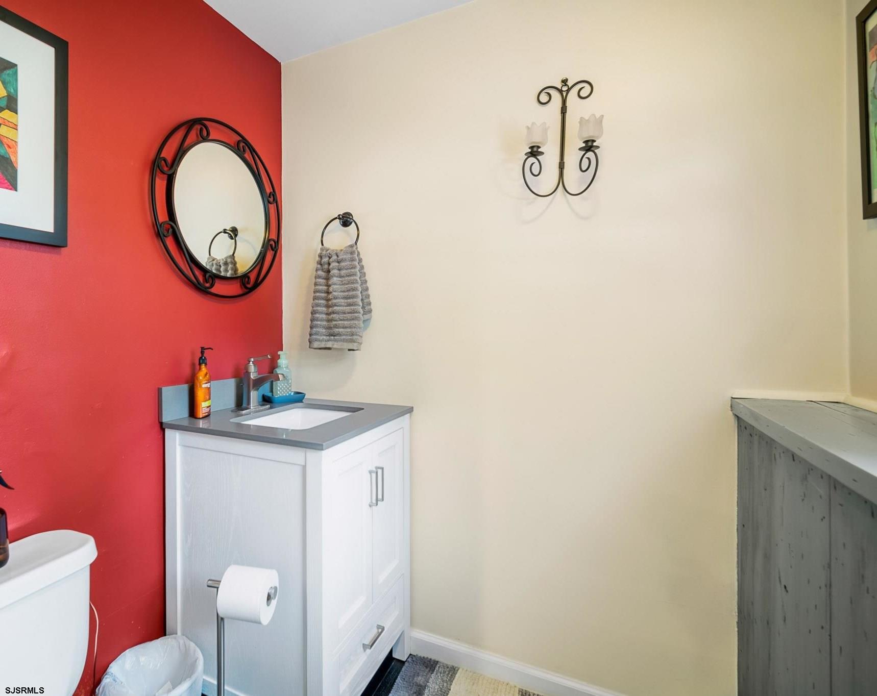 1326 Elwood Road Hammonton, NJ 08037 - Photo 13 of 36 a bathroom with a toilet sink vanity and mirror