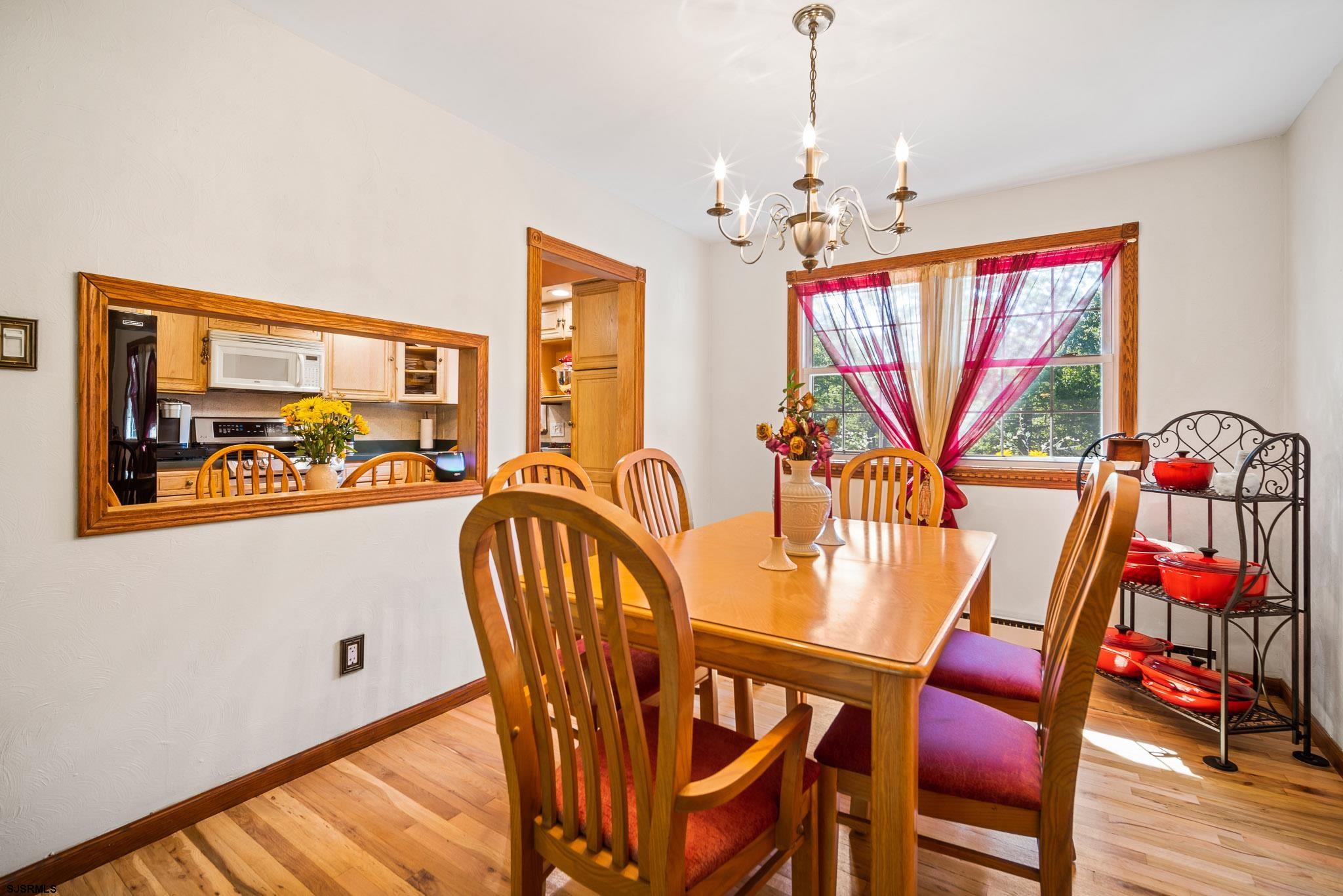 1326 Elwood Road Hammonton, NJ 08037 - Photo 19 of 36 a view of a dining room with furniture wooden floor and a chandelier