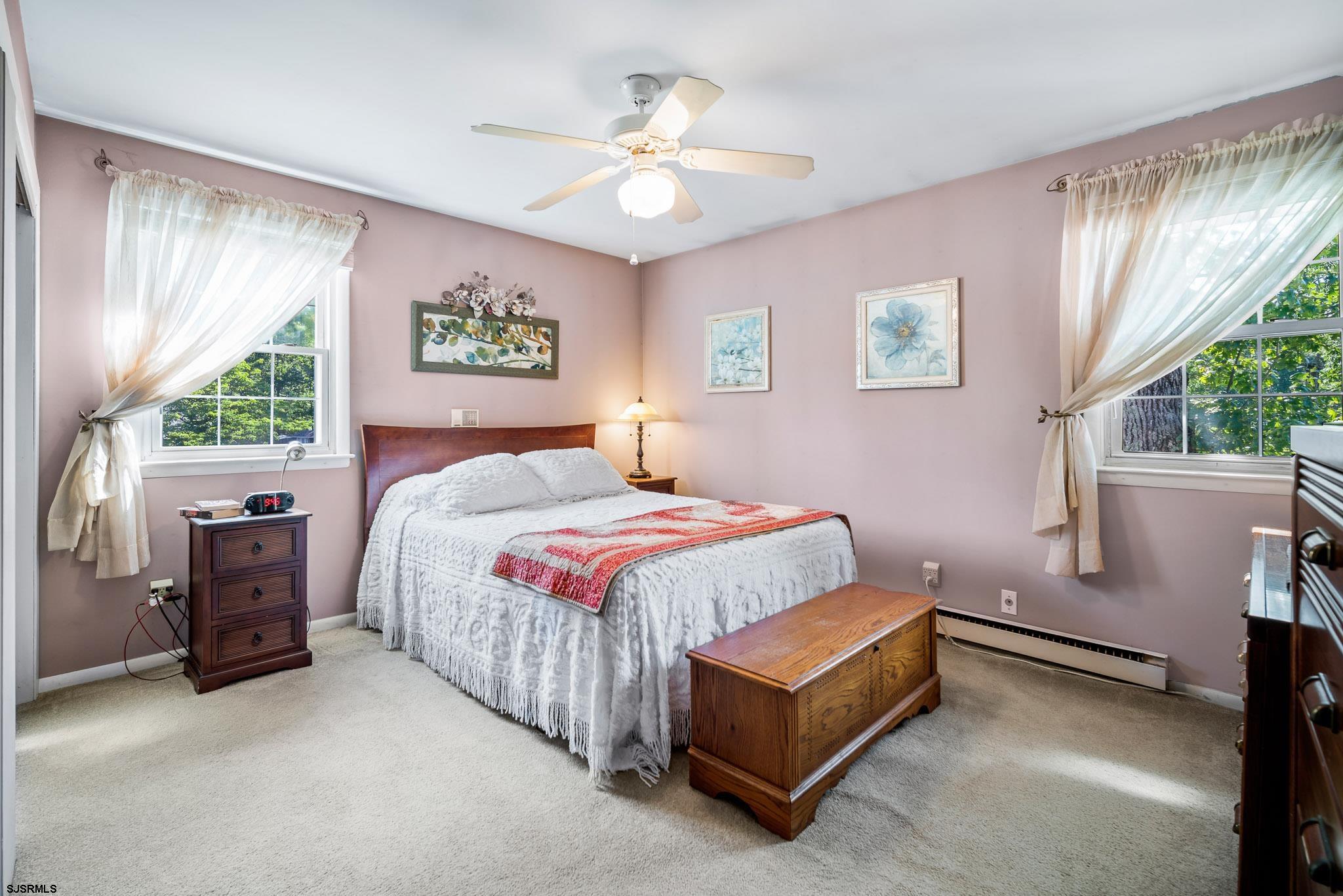 1326 Elwood Road Hammonton, NJ 08037 - Photo 24 of 36 a spacious bedroom with a bed and a chandelier