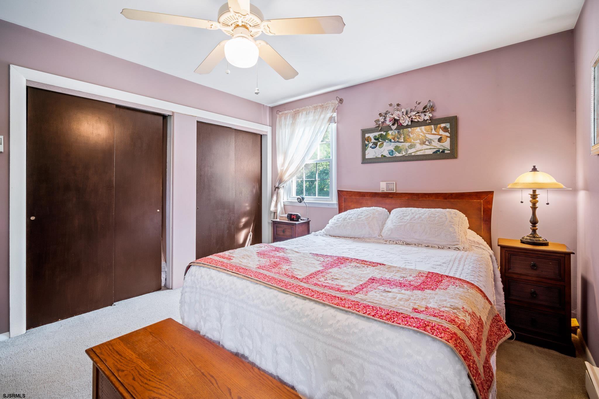 1326 Elwood Road Hammonton, NJ 08037 - Photo 25 of 36 a bedroom with a bed and a chandelier