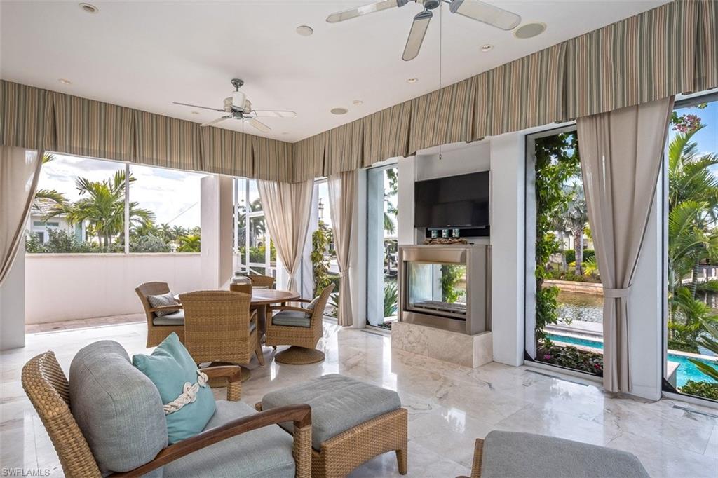 2290 Tarpon Road Naples, FL 34102 - Photo 13 of 35 a living room with furniture and large windows