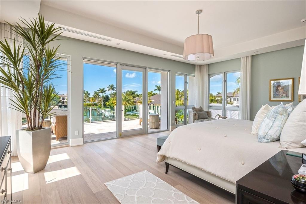 2290 Tarpon Road Naples, FL 34102 - Photo 15 of 35 a bedroom with a large bed and a large window