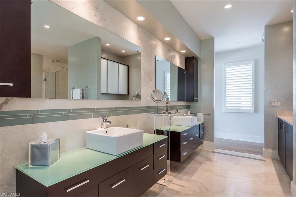 2290 Tarpon Road Naples, FL 34102 - Photo 16 of 35 a spacious bathroom with a double vanity sink mirror and