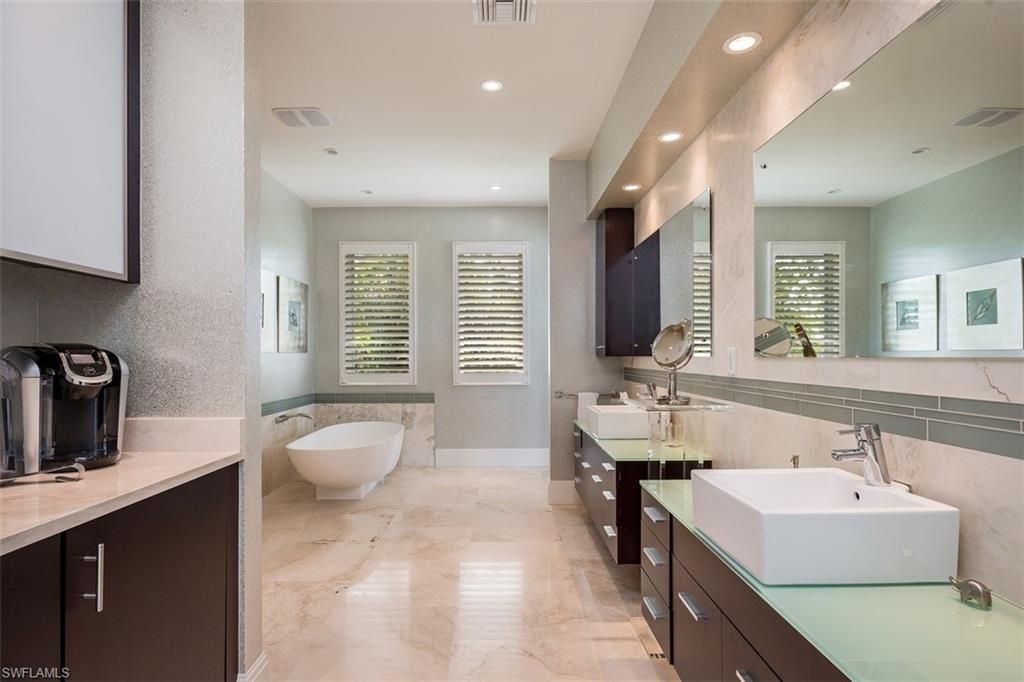 2290 Tarpon Road Naples, FL 34102 - Photo 17 of 35 a bathroom with a sink double vanity and a mirror