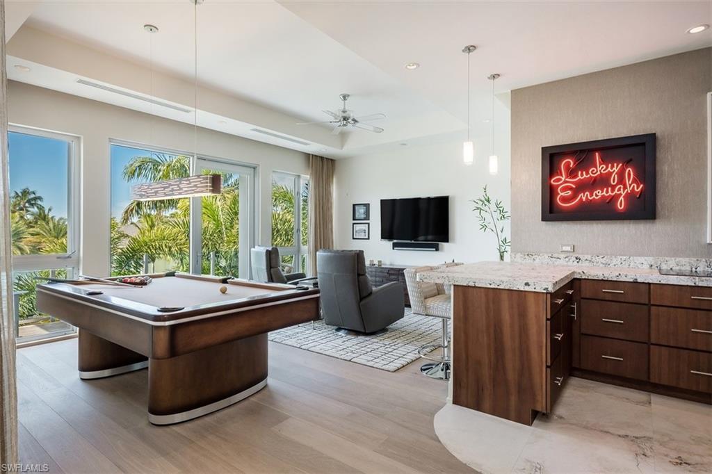 2290 Tarpon Road Naples, FL 34102 - Photo 20 of 35 a room with furniture flat screen tv and windows