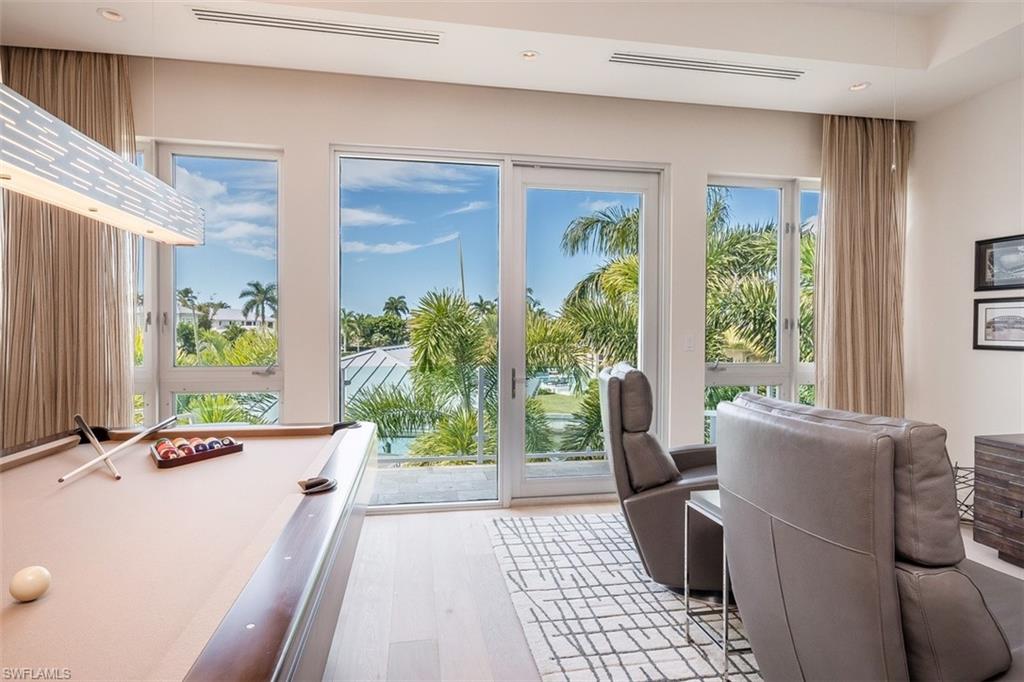 2290 Tarpon Road Naples, FL 34102 - Photo 21 of 35 a living room with furniture and a window