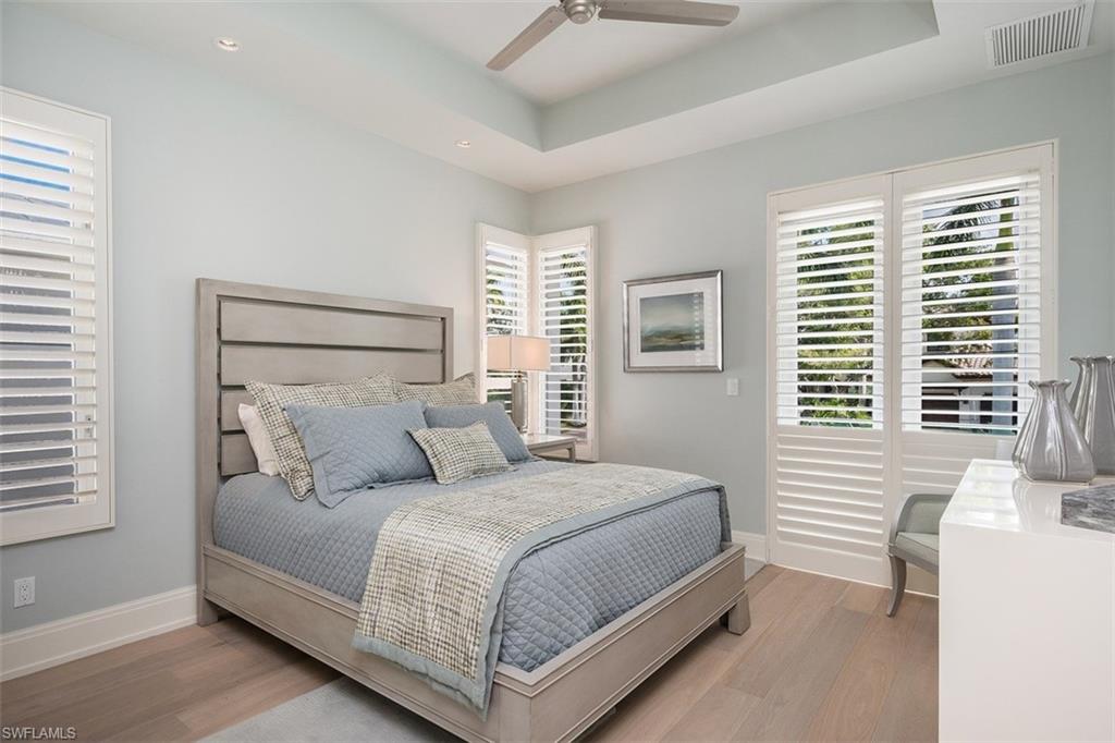 2290 Tarpon Road Naples, FL 34102 - Photo 22 of 35 a bedroom with a bed and windows