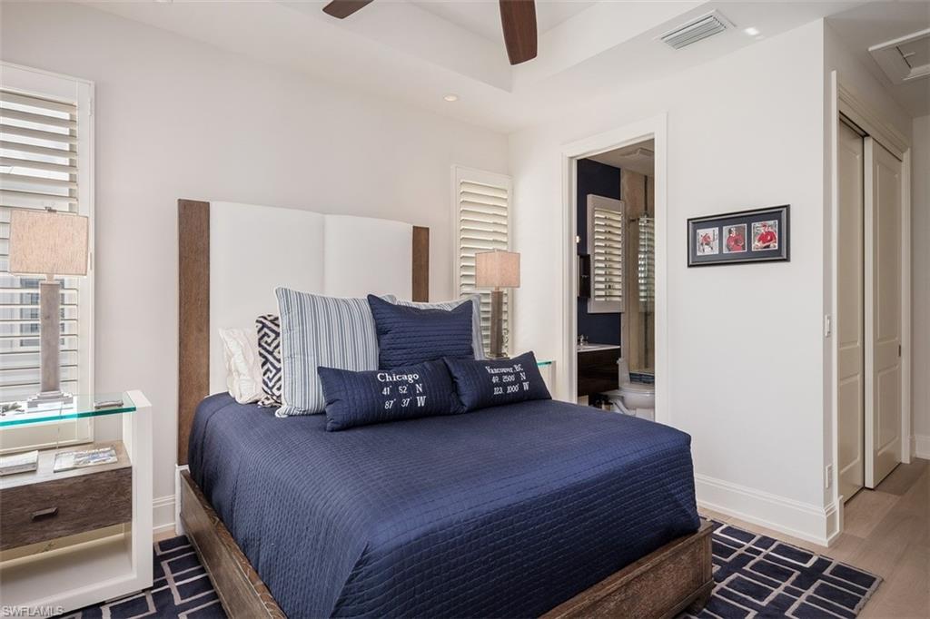 2290 Tarpon Road Naples, FL 34102 - Photo 25 of 35 a bedroom with a bed and wooden floor