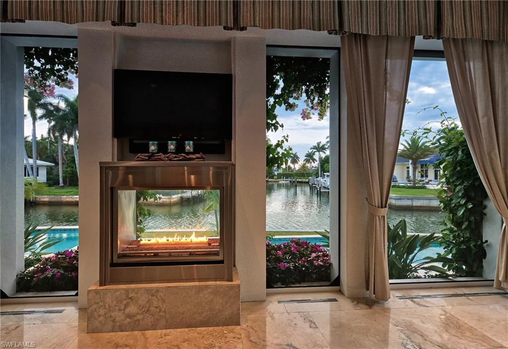 2290 Tarpon Road Naples, FL 34102 - Photo 33 of 35 a living room with furniture and a flat screen tv