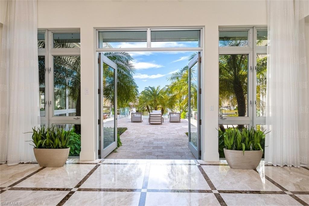 2290 Tarpon Road Naples, FL 34102 - Photo 4 of 35 a view of a porch with potted plants