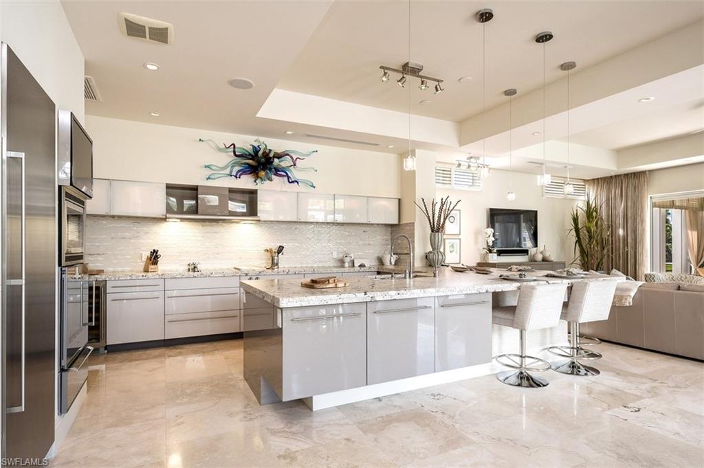 2290 Tarpon Road Naples, FL 34102 - Photo 8 of 35 a kitchen with counter top space cabinets and stainless steel appliances
