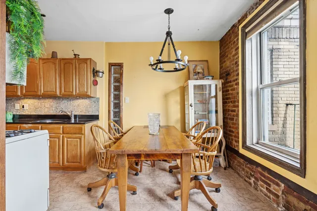 a view of a dining room with furniture and a window