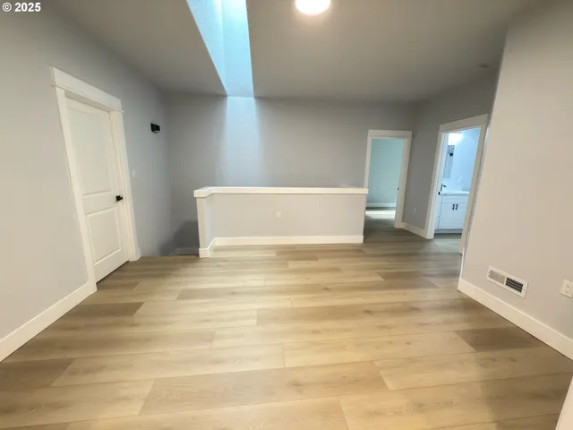 a view of a room & wooden floor