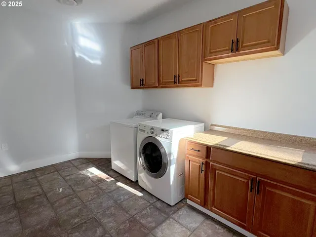 a utility room with sink dryer and washer