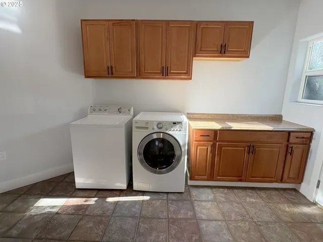 a utility room with sink dryer and washer