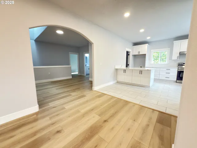 a view of kitchen with granite countertop cabinets and sink