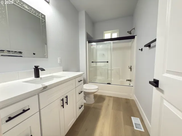 a spacious bathroom with a shower sink and a toilet