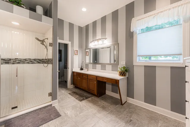a bathroom with a tub sink and mirror