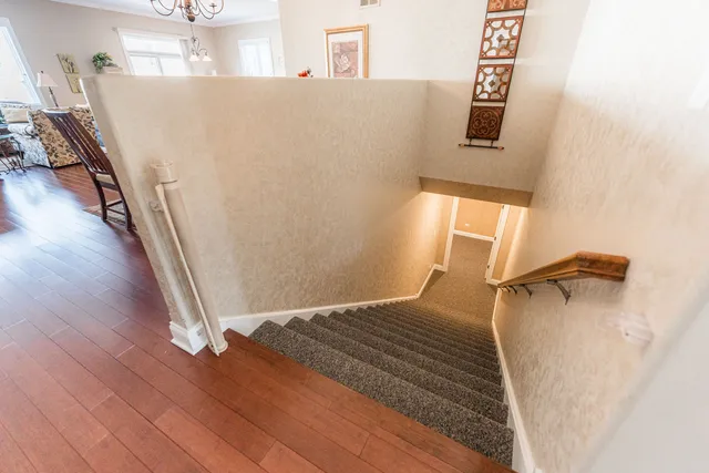 a view of a bedroom with wooden floor and stairs