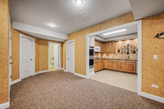a view of a kitchen with a sink and a refrigerator