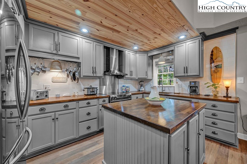 607 Charter Hills Road Beech Mountain, NC 28604 - Photo 3 of 31 a kitchen with granite countertop a sink stainless steel appliances and cabinets