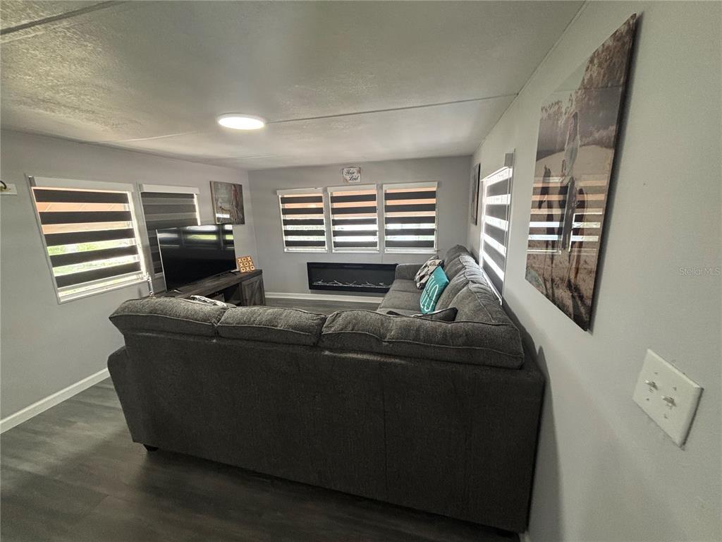 6141 Southwest 57th Court Ocala, FL 34474 - Photo 2 of 8 a living room with furniture and a fireplace