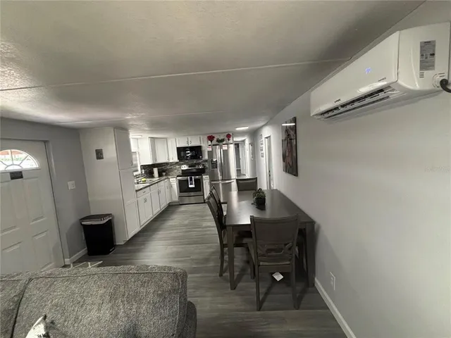 a open kitchen with cabinets table and stainless steel appliances