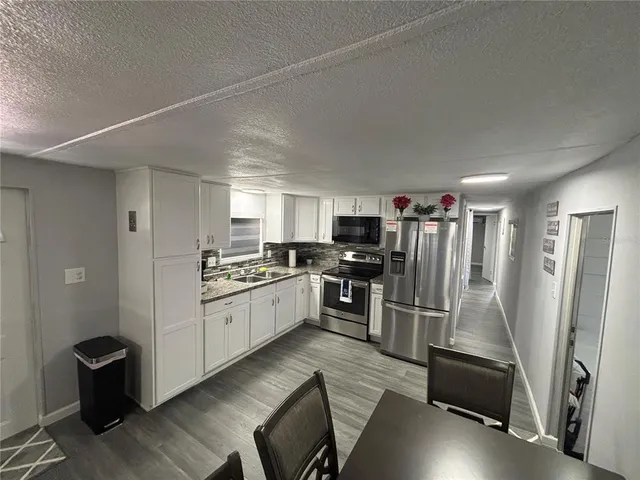 a kitchen with refrigerator and window