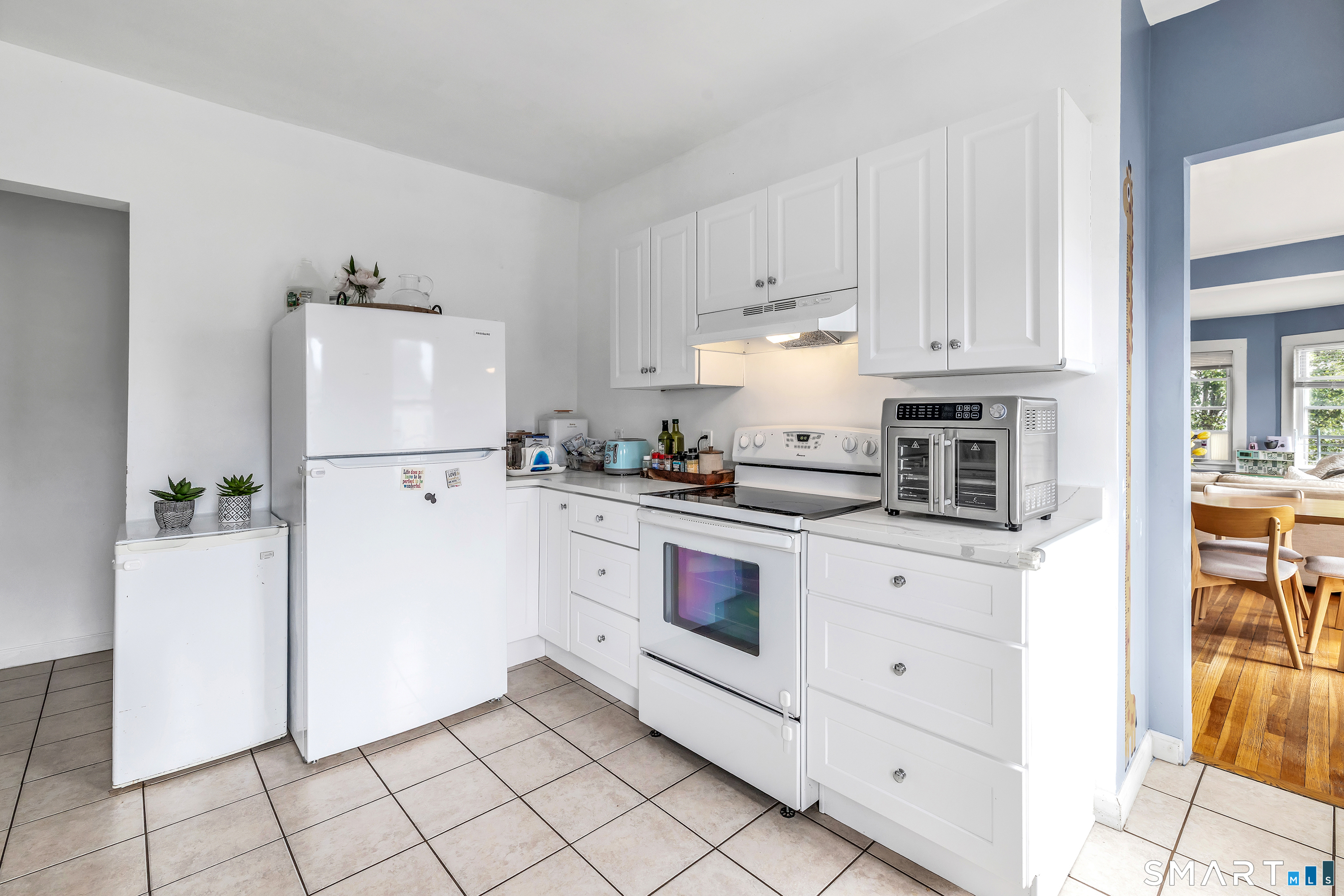 189 Wells Street Bridgeport, CT 06606 - Photo 13 of 40 2nd Floor Offers 1389 sq ft -new kitchen - quartz countertops, abundance of white cabinets, electric stove, fridge, dishwasher, washer/dryer