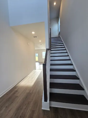 a view of entryway and hall with wooden floor