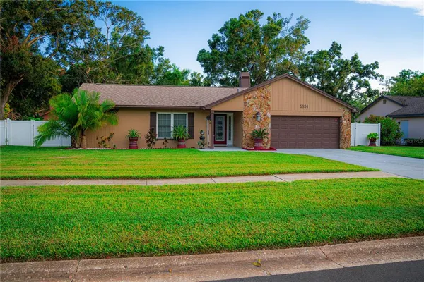 a front view of house with yard and green space