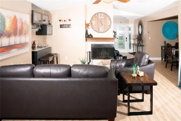 a living room with furniture a ceiling fan and a window