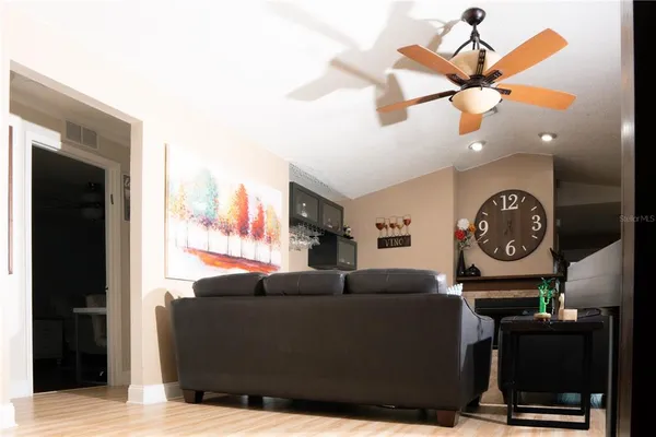 a kitchen with stainless steel appliances granite countertop a table chairs microwave and sink