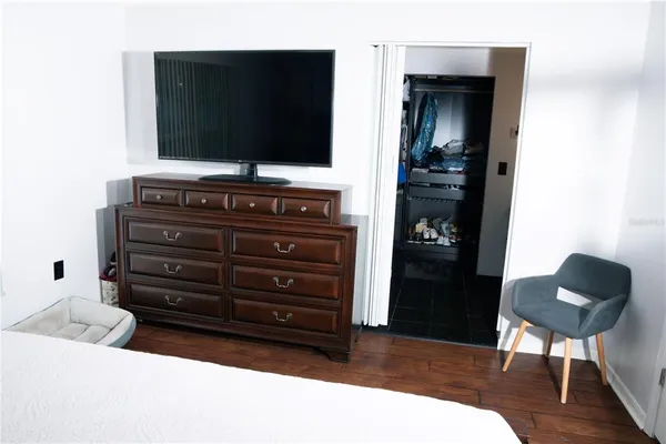 a room with a walk in closet and wooden floor