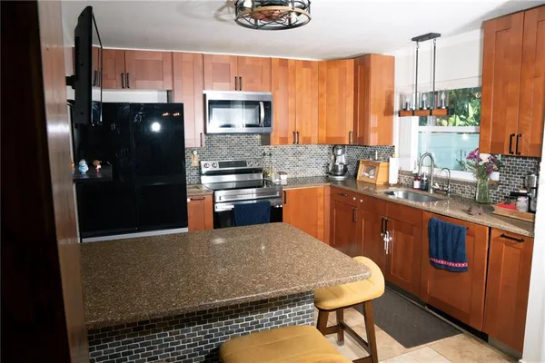 a living room with furniture a clock and a flat screen tv