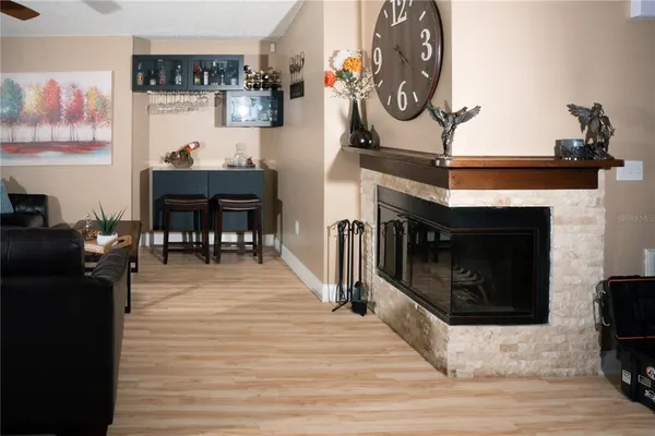 a living room with furniture a fireplace and a window