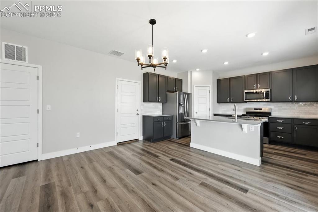 9891 Hidden Ranch Court Peyton, CO 80831 - Photo 11 of 44 a kitchen with stainless steel appliances a refrigerator sink and microwave