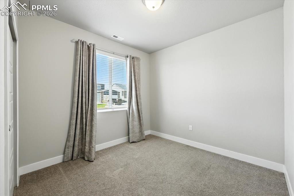 9891 Hidden Ranch Court Peyton, CO 80831 - Photo 15 of 44 an empty room with windows