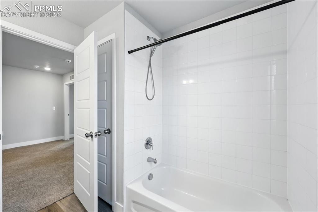 9891 Hidden Ranch Court Peyton, CO 80831 - Photo 17 of 44 a bathroom with a shower and a bath tub